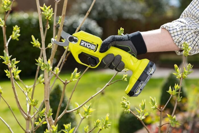 Ryobi garden tools secateurs being used comfortably with thick gardening gloves, reducing fatigue.